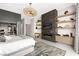 This main bedroom includes a modern fireplace, mounted TV, and custom shelving for decor at 387 Solitude Peak Ln, Henderson, NV 89012