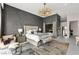 This main bedroom features a luxury chandelier, modern décor, and a relaxing space to unwind at 387 Solitude Peak Ln, Henderson, NV 89012