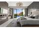 Elegantly decorated main bedroom with modern fireplace, pool view, and stylish light fixture at 387 Solitude Peak Ln, Henderson, NV 89012
