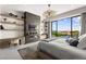 Serene bedroom with floor-to-ceiling windows, fireplace and stylish decor, creating a peaceful retreat with views at 387 Solitude Peak Ln, Henderson, NV 89012