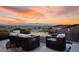 Serene outdoor patio with comfortable seating and a fire pit, perfect for enjoying the breathtaking sunset views at 387 Solitude Peak Ln, Henderson, NV 89012