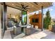 Stylish outdoor patio featuring a ceiling fan, built-in TV, and comfortable seating perfect for entertaining at 387 Solitude Peak Ln, Henderson, NV 89012