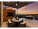 Stylish outdoor area with a TV, ceiling fan, and elegant seating with a grill nearby and a view of the mountains at 387 Solitude Peak Ln, Henderson, NV 89012