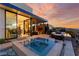 Inviting outdoor patio features a hot tub, comfortable seating, and sunset views, perfect for relaxing and entertaining at 387 Solitude Peak Ln, Henderson, NV 89012