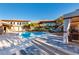 Resort-style pool area with a covered cabana and elegant lounge seating for ultimate relaxation and upscale outdoor experience at 387 Solitude Peak Ln, Henderson, NV 89012