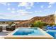 A modern pool and spa offers a tranquil retreat with a stunning view of the mountain and city at 387 Solitude Peak Ln, Henderson, NV 89012