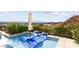 Inviting plunge pool with lounge chairs offers stunning views of the surrounding landscape and city skyline at 387 Solitude Peak Ln, Henderson, NV 89012