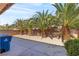 Landscaped backyard featuring decorative rock and palm trees providing a tranquil outdoor setting at 4043 Lilac Creek Ct, Las Vegas, NV 89122