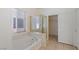 Bright bathroom featuring a bathtub, shower, and access to a walk-in closet at 4043 Lilac Creek Ct, Las Vegas, NV 89122