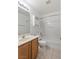 Bathroom featuring wood cabinets, a large mirror, a toilet, and a shower with a tub at 4043 Lilac Creek Ct, Las Vegas, NV 89122