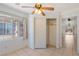 Bedroom featuring neutral walls, tile floors, a ceiling fan, a bright window with curtains, and a closet at 4043 Lilac Creek Ct, Las Vegas, NV 89122
