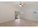 Spacious bedroom with a ceiling fan, a sliding glass door, and neutral color palette at 4043 Lilac Creek Ct, Las Vegas, NV 89122