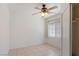 Bedroom featuring neutral walls, tile floors, a ceiling fan, a bright window with curtains, and a closet at 4043 Lilac Creek Ct, Las Vegas, NV 89122