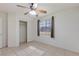 Bedroom featuring neutral walls, tile floors, a ceiling fan, a bright window with curtains, and a closet at 4043 Lilac Creek Ct, Las Vegas, NV 89122