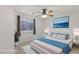 Cozy bedroom featuring neutral walls, tile floors, ceiling fan, and a bright window with curtains at 4043 Lilac Creek Ct, Las Vegas, NV 89122
