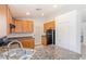 Well-lit kitchen features wood cabinetry, granite counters, and stainless steel appliances at 4043 Lilac Creek Ct, Las Vegas, NV 89122