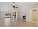 Open-concept living room with tiled floors, fireplace, and backyard access, perfect for entertaining at 4043 Lilac Creek Ct, Las Vegas, NV 89122