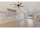 Bright and airy living room with tiled floors, two ceiling fans and sliding doors to the back at 4043 Lilac Creek Ct, Las Vegas, NV 89122