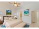 Staged primary bedroom with ensuite bathroom featuring tub, neutral tones and a ceiling fan at 4043 Lilac Creek Ct, Las Vegas, NV 89122