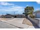 Street view of a single-story home featuring a long driveway and mature shade tree at 4272 Sheppard Dr, Las Vegas, NV 89121
