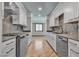 Galley kitchen with stainless steel appliances, light countertops, and sleek cabinetry at 4272 Sheppard Dr, Las Vegas, NV 89121