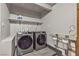 Modern laundry room equipped with new washer and dryer, and a utility sink at 4272 Sheppard Dr, Las Vegas, NV 89121