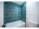 Modern bathroom features a tub with beautiful blue tiling and clean white fixtures at 4600 University Center Dr # 72, Las Vegas, NV 89119