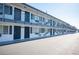Property exterior showcasing apartment fronts with blue railings and blue doors at 4600 University Center Dr # 72, Las Vegas, NV 89119