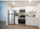 A modern kitchen with stainless steel appliances and white cabinets creates a clean and efficient cooking space at 4600 University Center Dr # 72, Las Vegas, NV 89119