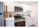 The kitchen has stainless appliances, white cabinets, and quartz counters at 4600 University Center Dr # 72, Las Vegas, NV 89119