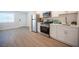 Modern kitchen with stainless appliances and white cabinets, next to the bright living room at 4600 University Center Dr # 72, Las Vegas, NV 89119