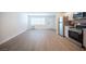 Bright living area with wood-look flooring and stainless steel appliances in the kitchen at 4600 University Center Dr # 72, Las Vegas, NV 89119