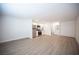 A bright open floor plan showcasing wood-look flooring, a modern kitchen with stainless appliances, and a bathroom with a vanity at 4600 University Center Dr # 72, Las Vegas, NV 89119