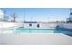 Community swimming pool surrounded by a white fence and lounge chairs at 4600 University Center Dr # 72, Las Vegas, NV 89119
