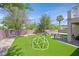 Spacious backyard with a geometric play structure, string lights, and an outdoor seating area at 50 Desert Castle Ct, Henderson, NV 89012