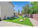 Expansive backyard featuring artificial grass, patio, and play area perfect for children at 50 Desert Castle Ct, Henderson, NV 89012
