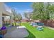 Backyard with green lawn and an outdoor lounge area, perfect for entertaining and relaxation at 50 Desert Castle Ct, Henderson, NV 89012