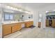 Spacious bathroom with double sink vanity, large mirror, and a walk-in closet at 50 Desert Castle Ct, Henderson, NV 89012
