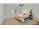 Neutral bedroom with a queen bed, natural light, and a leafy green plant at 50 Desert Castle Ct, Henderson, NV 89012
