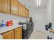 Functional laundry room with modern washer and dryer, plus plenty of storage cabinets at 50 Desert Castle Ct, Henderson, NV 89012