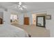 Spacious main bedroom with neutral carpet, ceiling fan, and adjacent dressing room and ensuite bath at 50 Desert Castle Ct, Henderson, NV 89012