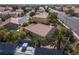 Aerial view featuring the home's tile roof, mature trees, and desert landscaping at 5049 Running Rapids Ave, Las Vegas, NV 89130