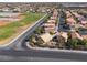 Expansive aerial view of a residential community with neat rows of houses and a green baseball field nearby at 5049 Running Rapids Ave, Las Vegas, NV 89130