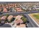 Aerial view of a well-maintained residential area, highlighting its proximity to local parks and roads at 5049 Running Rapids Ave, Las Vegas, NV 89130