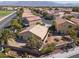 Aerial view of the home's tile roof, backyard, mature trees, and desert landscaping at 5049 Running Rapids Ave, Las Vegas, NV 89130