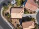 Overhead view displaying a home's roof, driveway, and surrounding landscaping, showcasing its location at 5049 Running Rapids Ave, Las Vegas, NV 89130