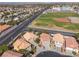 Neighborhood aerial with neat landscaping, wide streets, and community ball fields, close to modern residences at 5049 Running Rapids Ave, Las Vegas, NV 89130