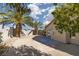 Backyard with desert landscaping, a concrete patio, block wall, mature trees, and a stucco exterior at 5049 Running Rapids Ave, Las Vegas, NV 89130