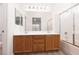 Bathroom featuring double sinks, a large mirror, and a shower-tub combination at 5049 Running Rapids Ave, Las Vegas, NV 89130