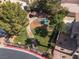 A community park with playground, covered picnic area, green grass, and paved sidewalks, ideal for families at 5049 Running Rapids Ave, Las Vegas, NV 89130